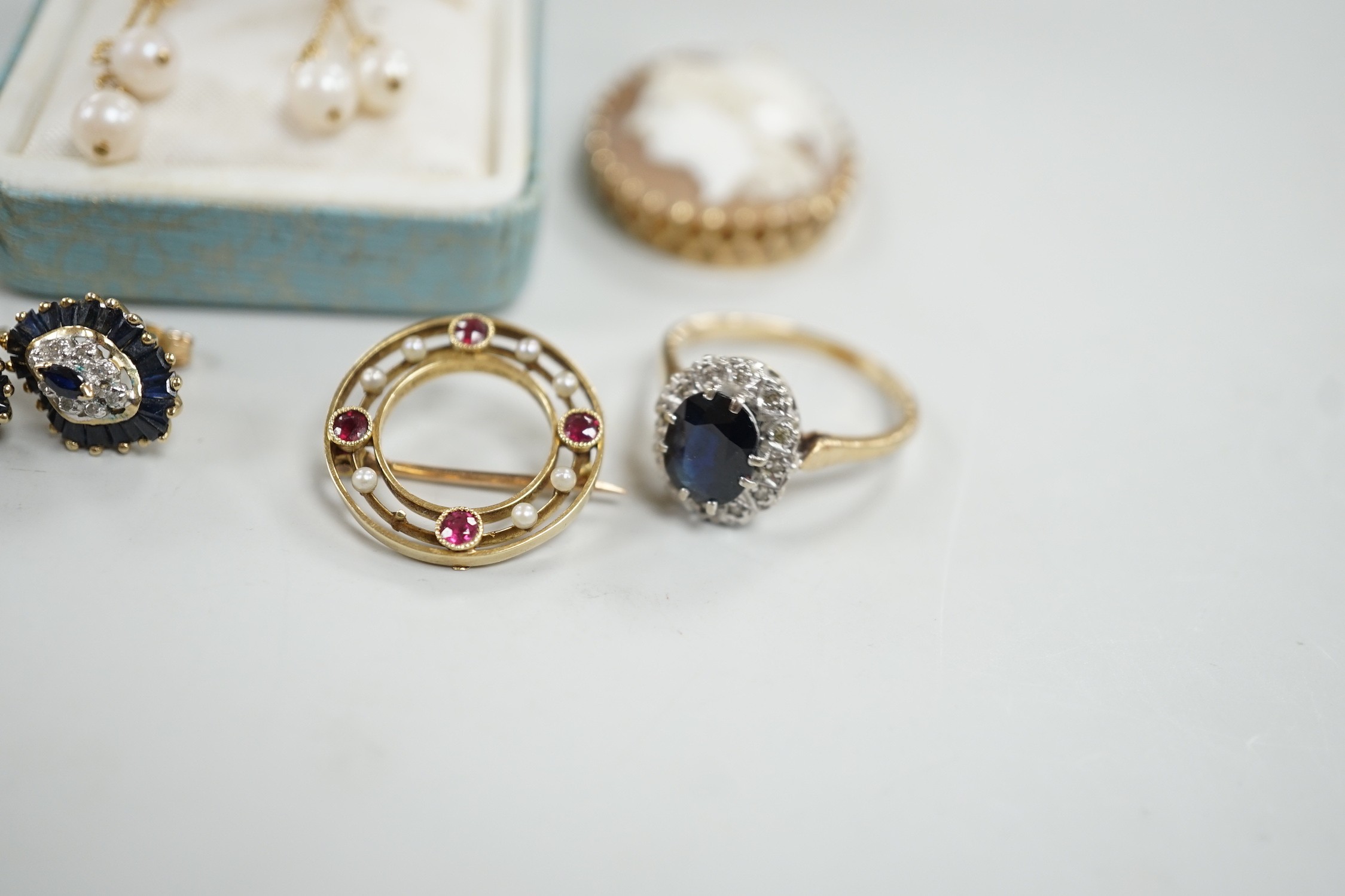 Mixed jewellery including two 9ct and gem set cluster rings and a 15ct, ruby and seed pearl set circular brooch, a yellow metal mounted oval cameo shell brooch, a pair of 9ct gold and gem set cluster ear studs, a 9ct whi